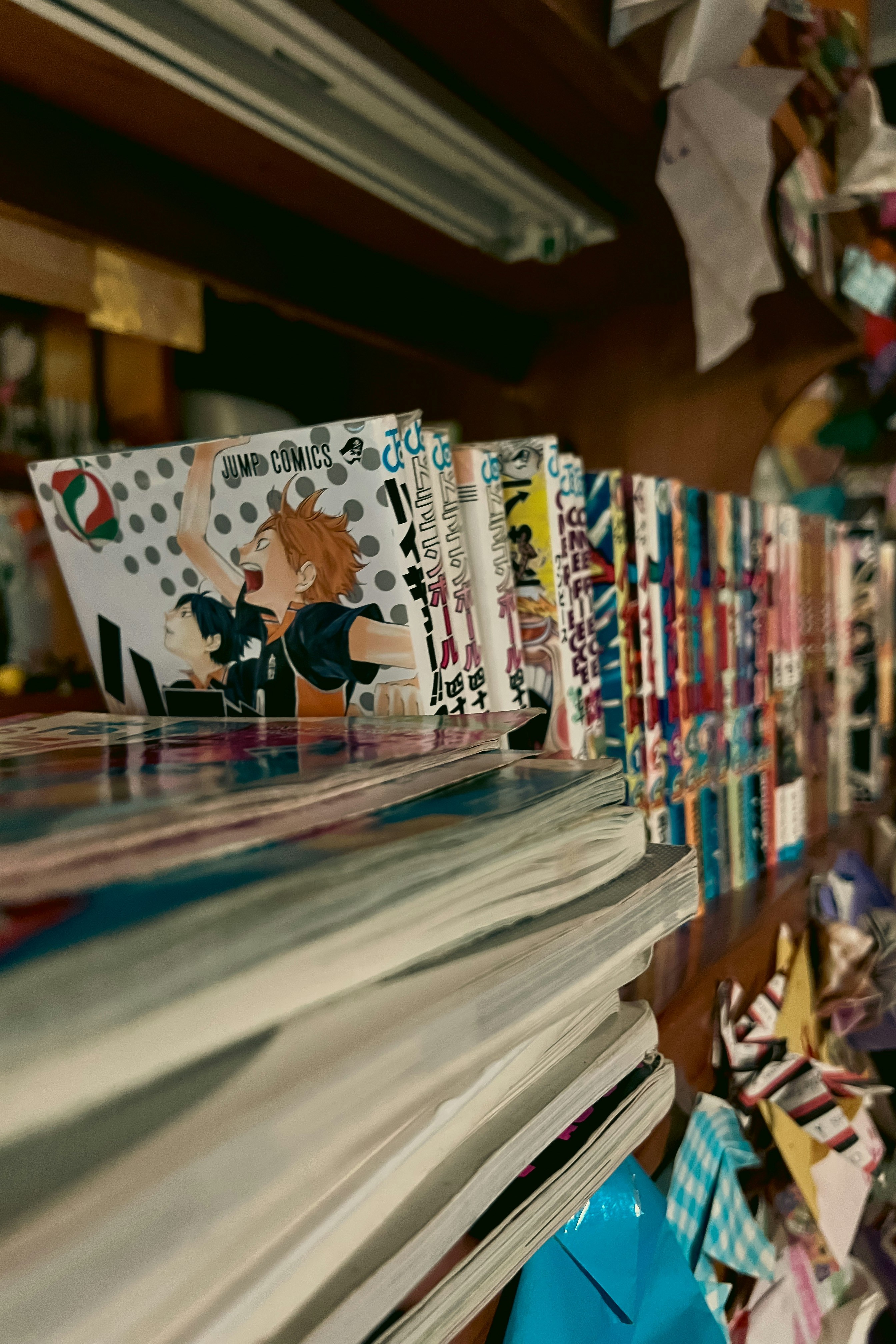 Close-up of manga books displayed on shelves in a Japanese bookstore