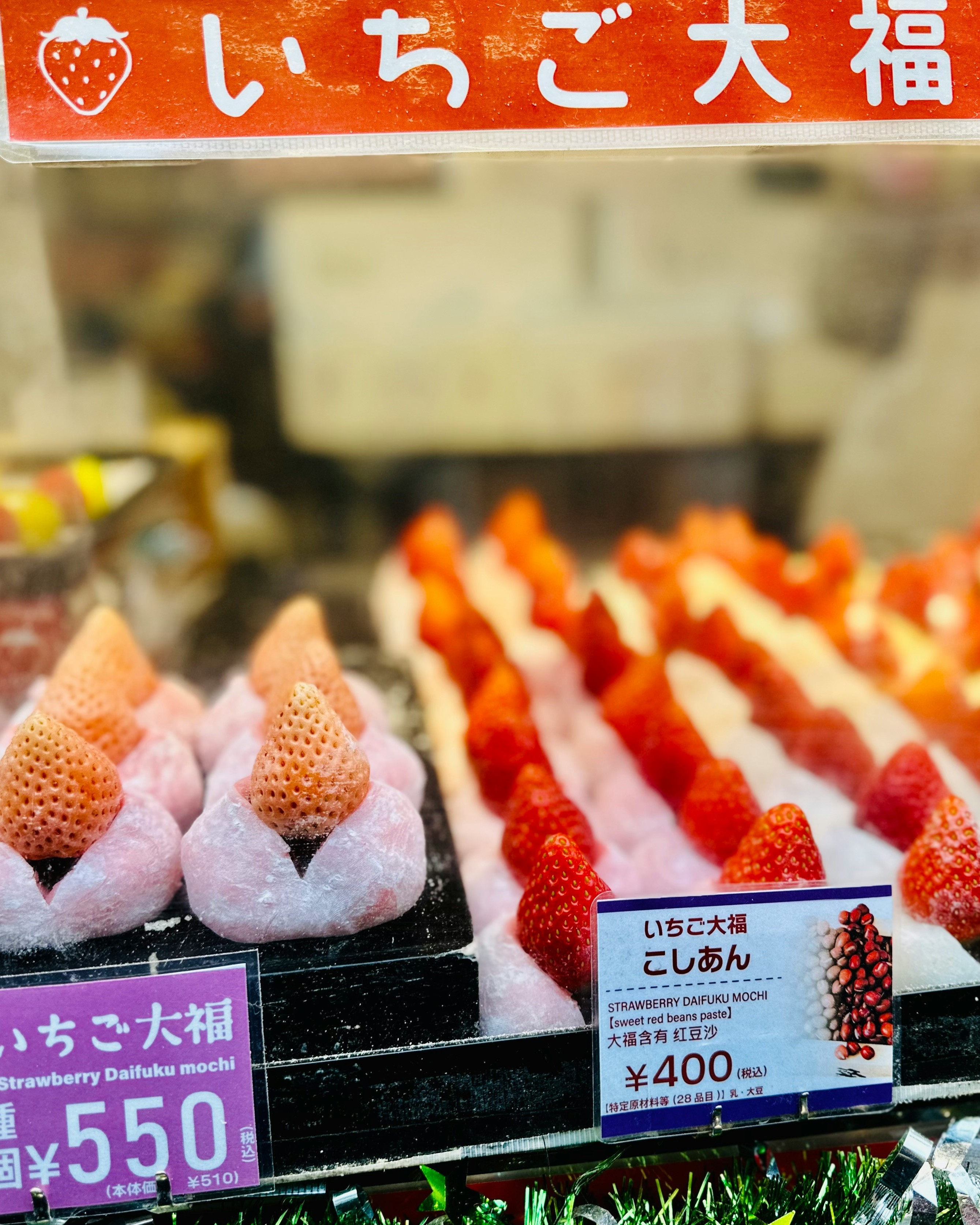 Japanese strawberry mochi desserts displayed at a market stall