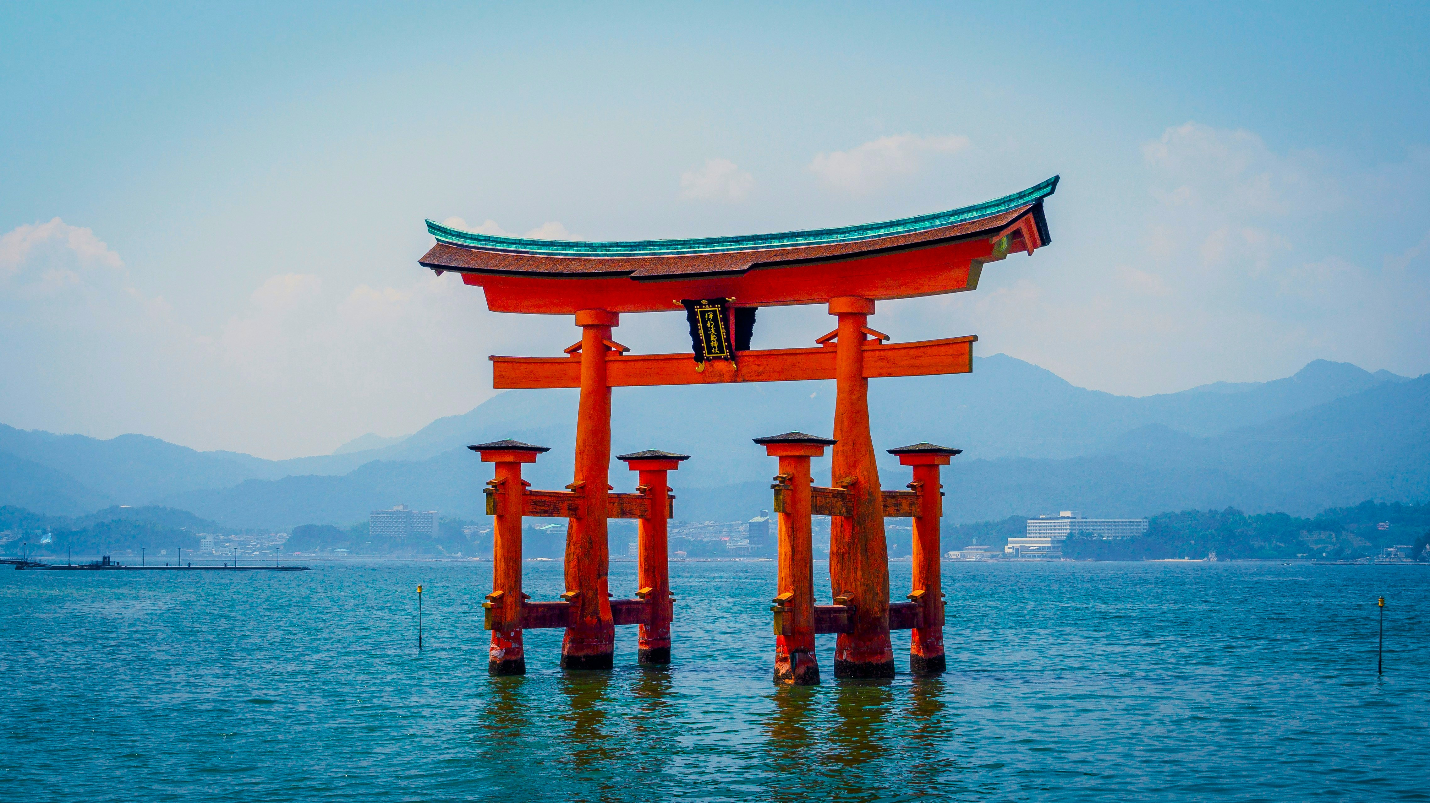 Red torii gate standing in the water at a Japanese shrine