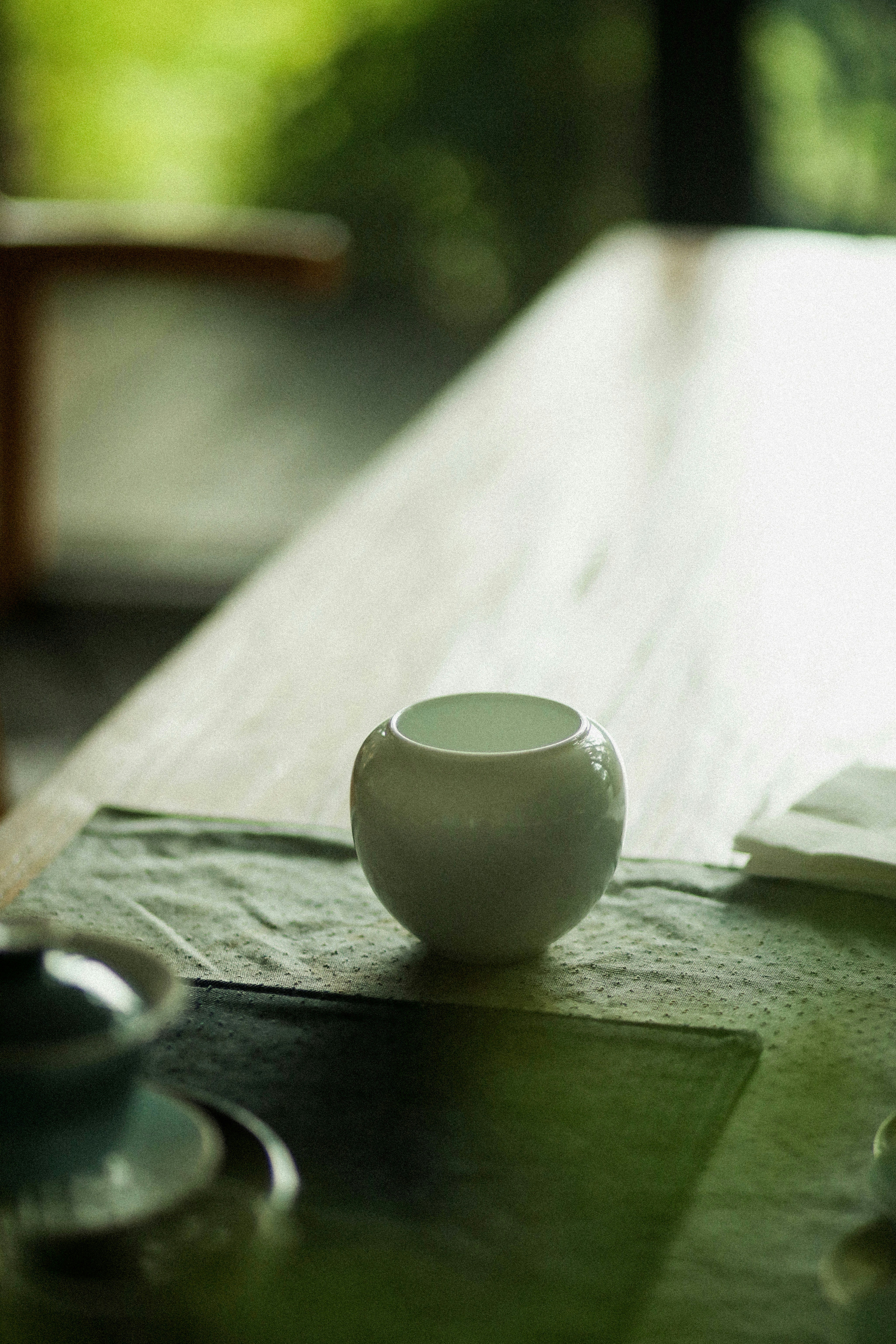Traditional Japanese tea set on a wooden table by a window